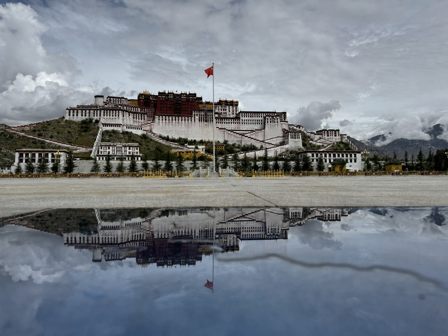 The Potala Palace and its reflection after rain beneath an overcast sky