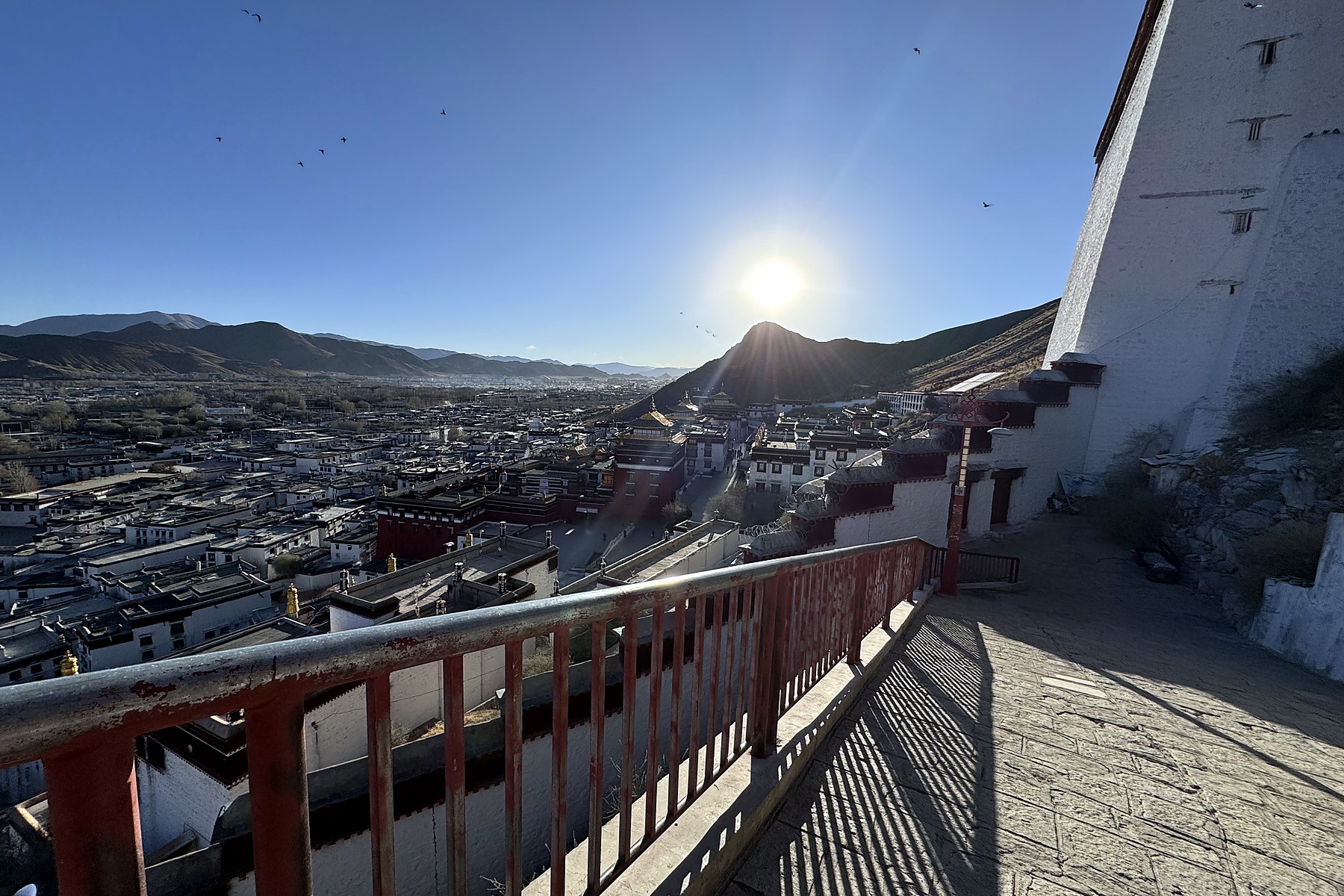 A winter afternoon over Shigatse, monastery buildings, and distant mountains
